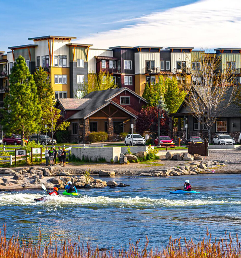 Reference image: a riverfront neighborhood with homes, apartments and kayakers on the water